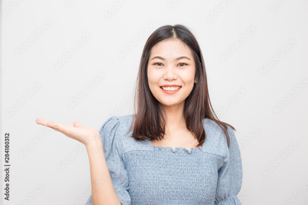 Beautiful smiling asian women show welcome hand gesture Beautiful smiling asian women show welcome hand gesture