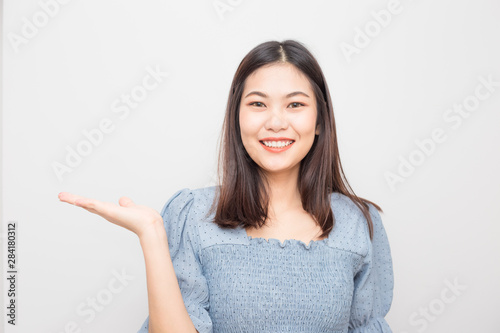 Beautiful smiling asian women show welcome hand gesture