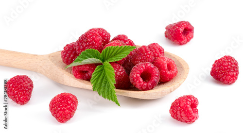 .raspberries on a wooden spoon on a white background