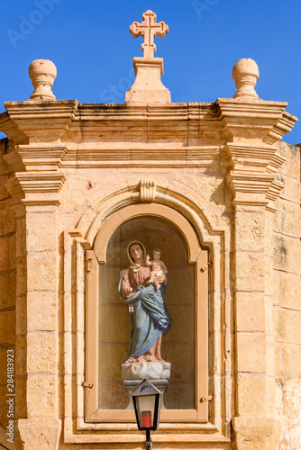 A shrine with a statue of the Virgin Mary holding the baby Jesus in Gozo, Malta. © Stephen