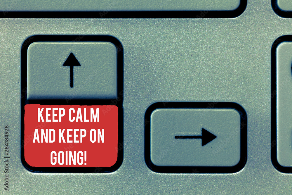 Fototapeta premium Conceptual hand writing showing Keep Calm And Keep On Going. Business photo text Get relaxed and continue moving taking action Keyboard Intention to create computer message keypad idea
