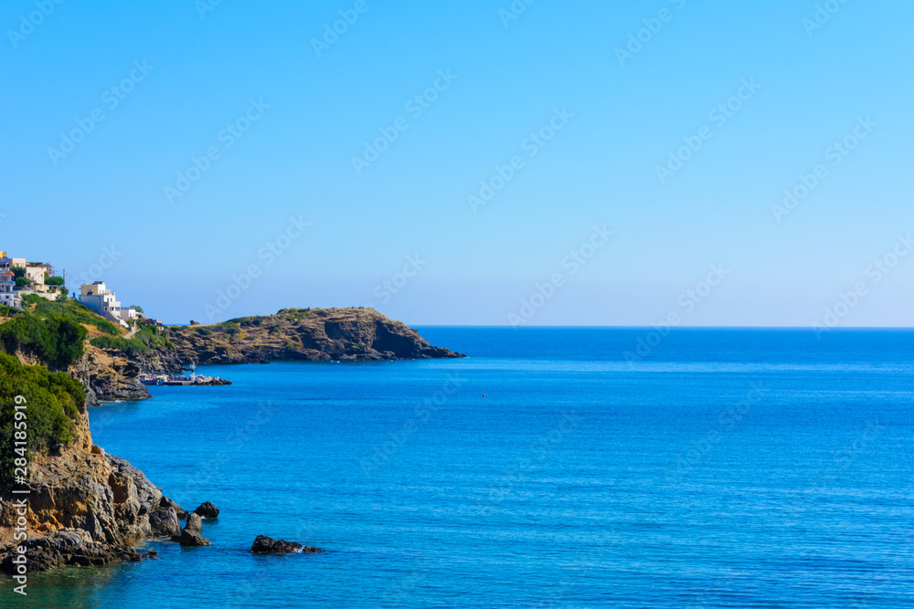 landscape view of the sea coast with a ledge. a Mediterranean village in a Bay with a small port. summer morning.