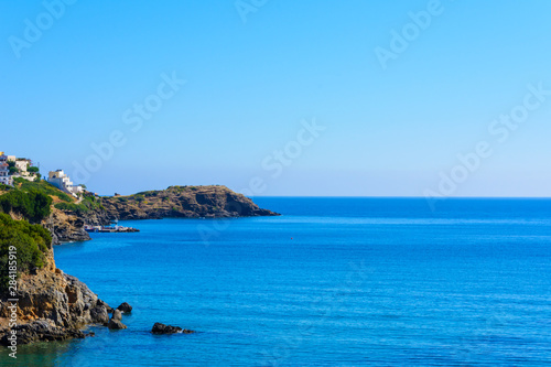landscape view of the sea coast with a ledge. a Mediterranean village in a Bay with a small port. summer morning.