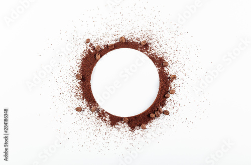Ground coffee and beans on white background.