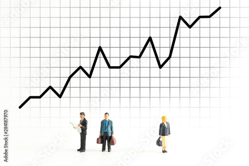 Miniature People Standing Below a Graph Fluctuating up and down © Sean