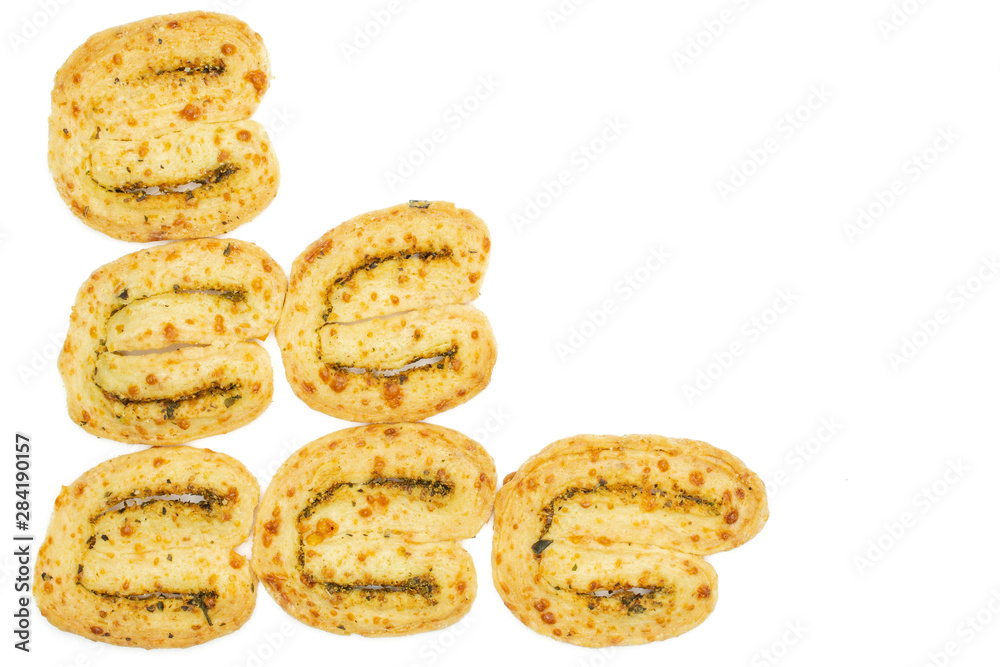 Group of six whole crisp savory cheese palmier flatlay isolated on white background