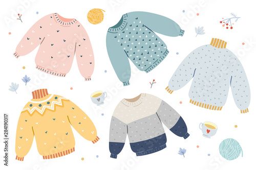Handdrawn vector illustrations of warm winter and autumn woolen sweaters in pastel scandinavian style colors. Trendy flat design elements of winter clothes. Christmas holidays mood. photo