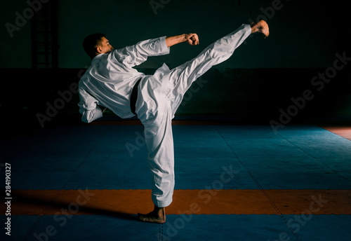 Taekwondo action isolated by a young man