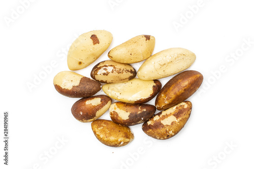 Lot of whole fresh unshelled brazil nut flatlay isolated on white background