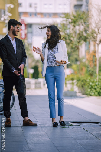 Smiling business man and woman chatting outdoor