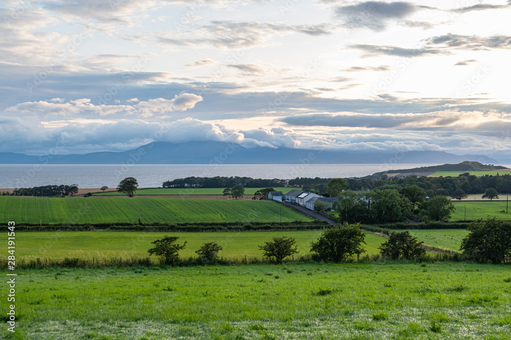 Scotland's Ayrshire Farmlands with Treelined hedges and a Cloud Covered Arran.