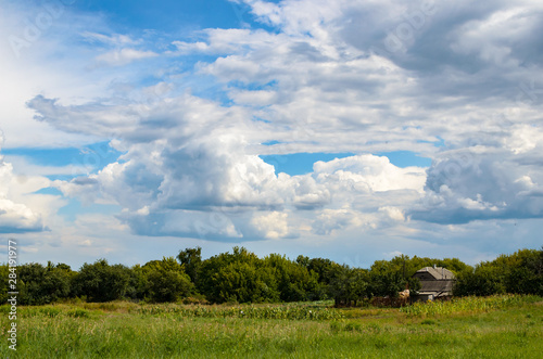 Fluffy clouds over the village © FellowNeko