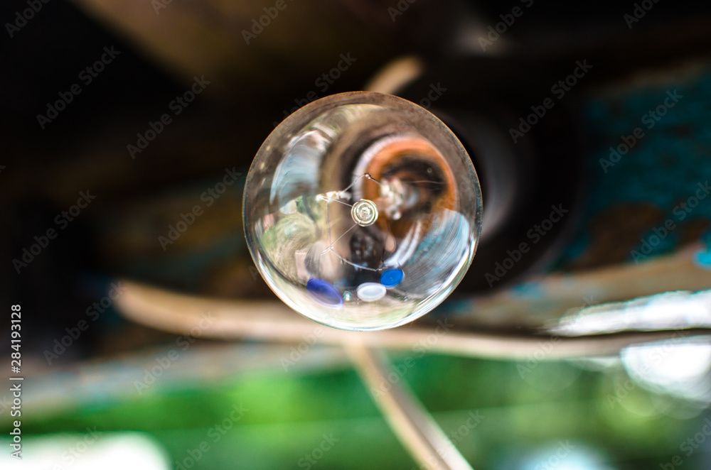 Macro photo of a light bulb, filament and reflection in it Macro photo of a light bulb, filament and reflection in it