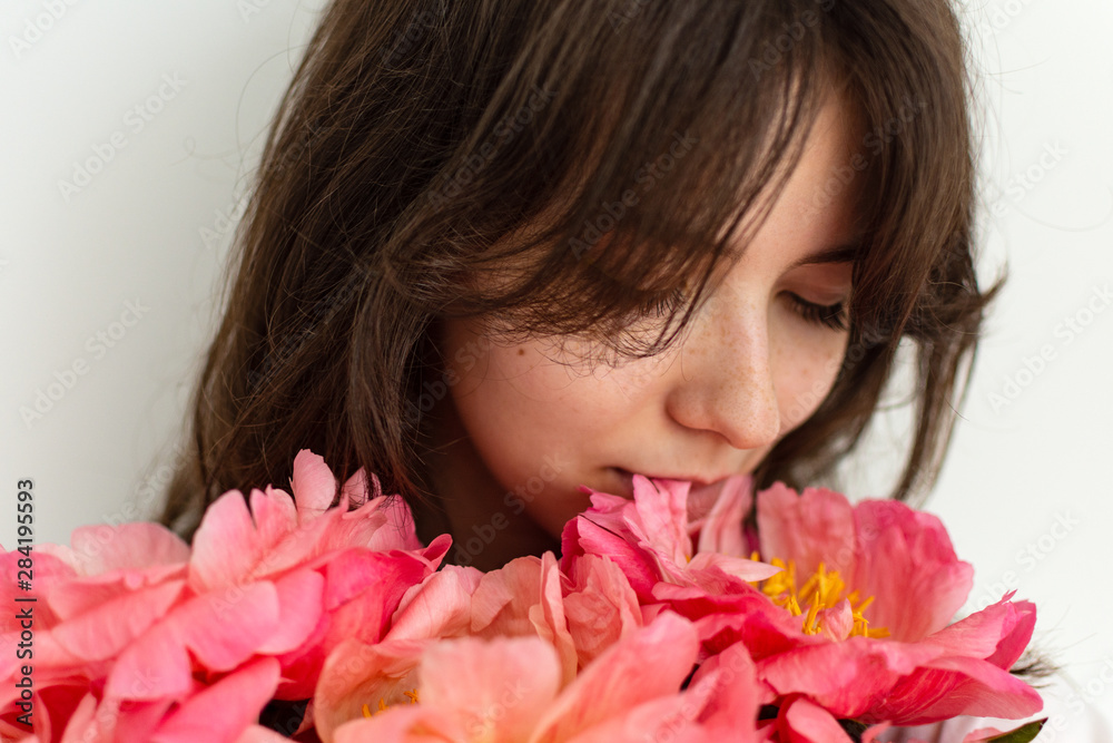 Beautiful girl with pink peonies close up, happy birthday or valentine's day Beautiful girl with pink peonies close up, happy birthday or valentine's day