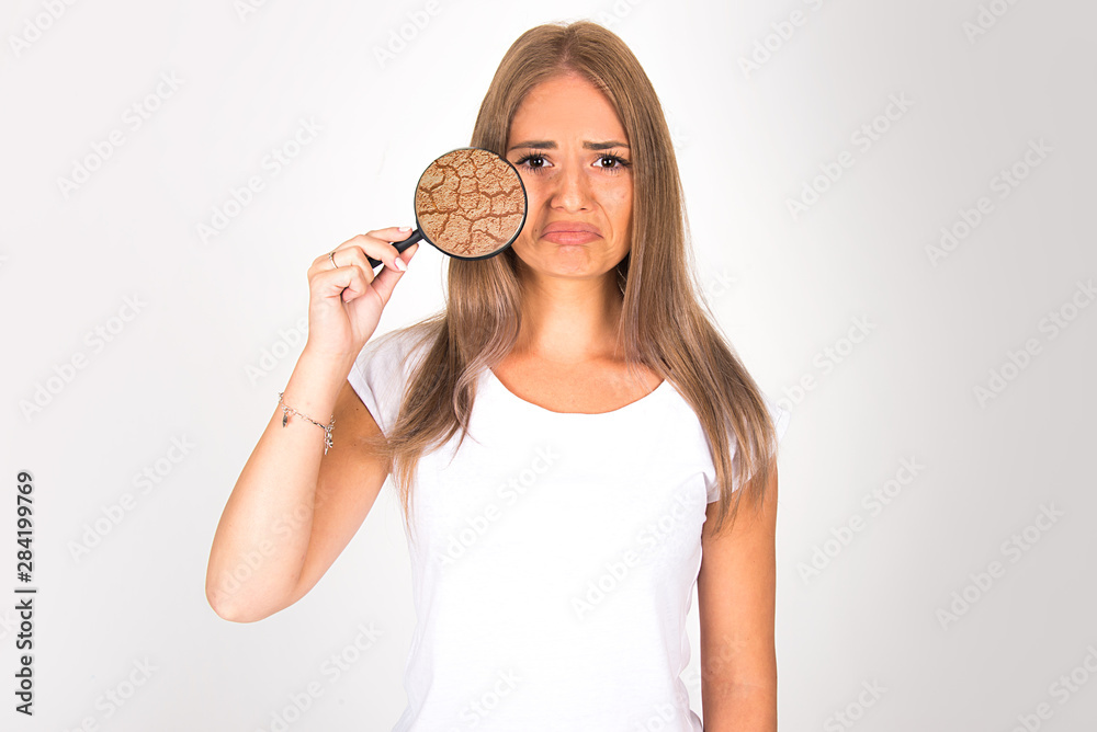 beautiful girl woman with skin problem concept holding magnifier dry and damaged skin close up