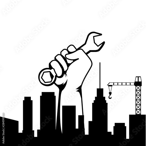 Construction worker hand holding tool in black and white