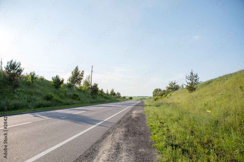 speed highway through the field. asphalt-paved road speed highway through the field. asphalt-paved road