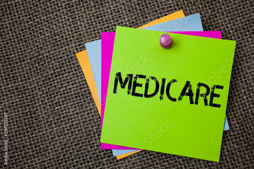 Handwriting text writing Medicare. Concept meaning Federal health insurance for people above 65 or with disabilities Sticky cards board pinned muliple colours remember idea jute background photo