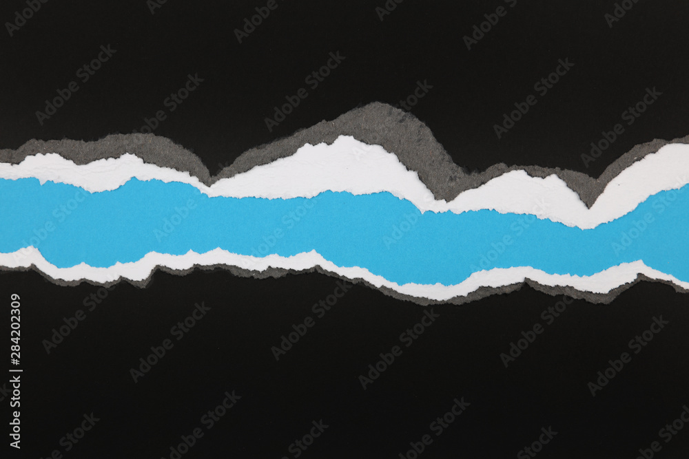 Fototapeta premium Ripped paper on blue