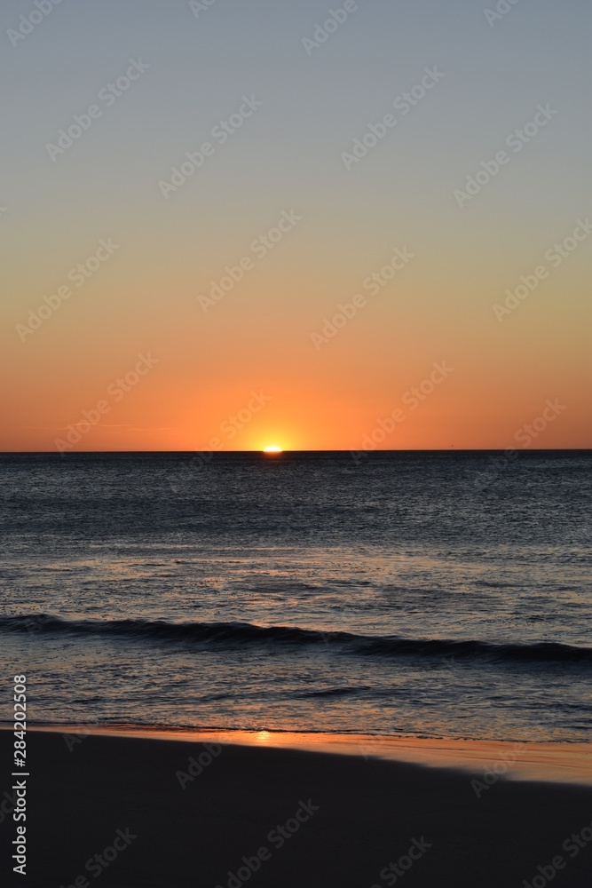 Sunset on the beach, orange, yellow and red colors.