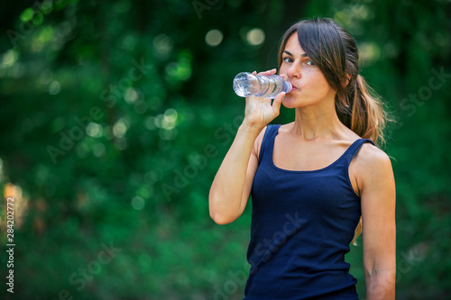 a girl drinks water after sport
