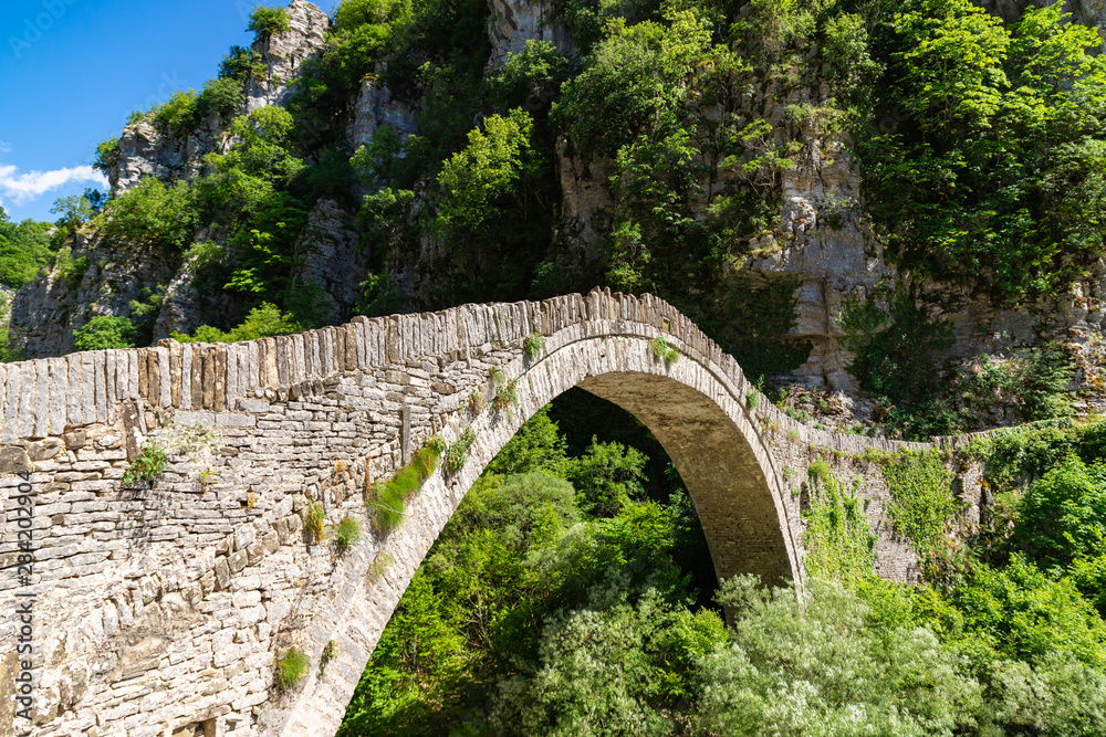 Bridge of Kokkoros or Noutsos in Epirus mountain greek region. One-arch stone bridge situated on the river of Voidomatis in the municipality of Central Zagori. Zagorohoria, Greece.