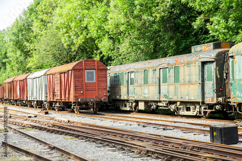 Various rusted wagons and train on the tracks