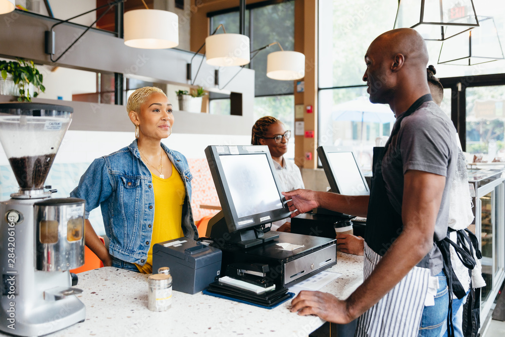 Man serving customer at cafe Man serving customer at cafe
