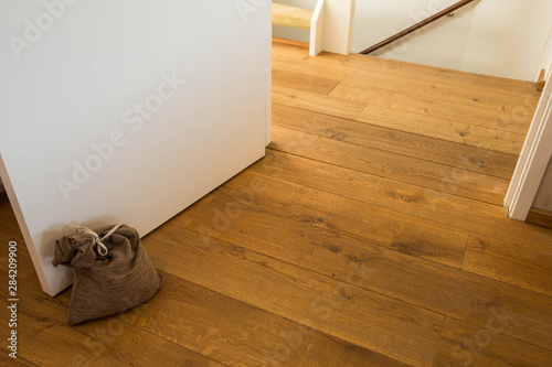 Door stopper on laminate floor.Door stopper to prevent bumps while opening doors. photo