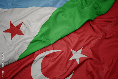 waving colorful flag of turkey and national flag of djibouti.