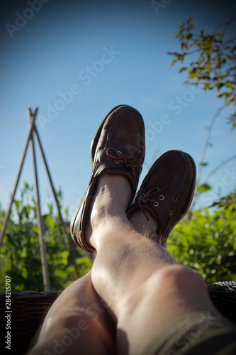 man putting his feet up at the allotment