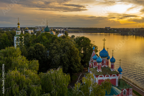 Uglich, Russia. Embankment of the Volga river in Uglich, the temple of Dmitry on Blood in the evening twilight, at sunset photo