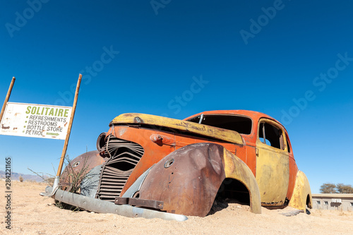 Wrecks of historic cars line the road in the town of Solitaire in the Khomas Region of Namibia.