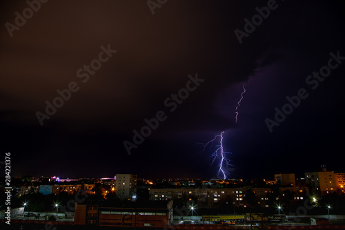 Purple lightning above city