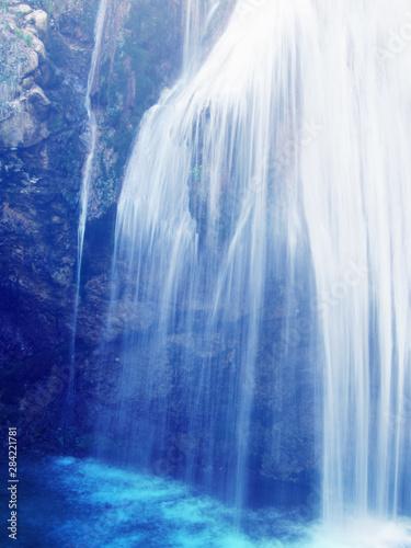 Waterfall strings blule azure colored water drops nature sceene  photo
