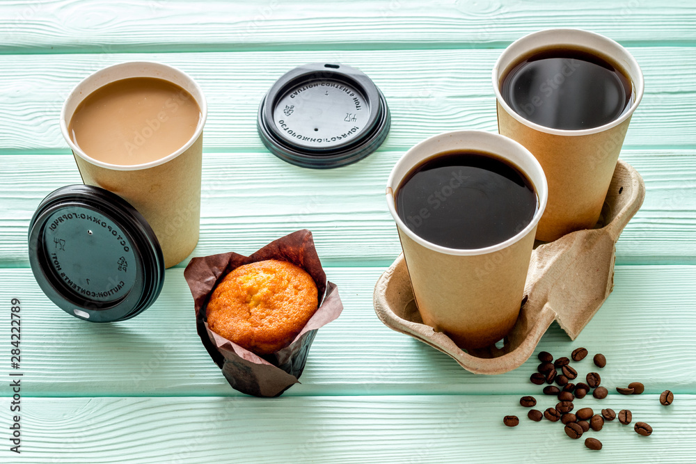 Coffee to go on mint green wooden background