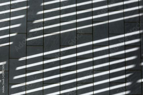 Pattern of shadows on a tile floor