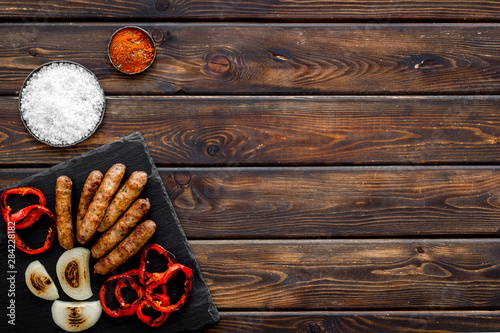 barbecue, sausages, vegetables on wooden background top view mockup