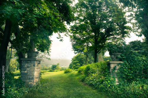 Beautiful green landscape with trees and stone gates