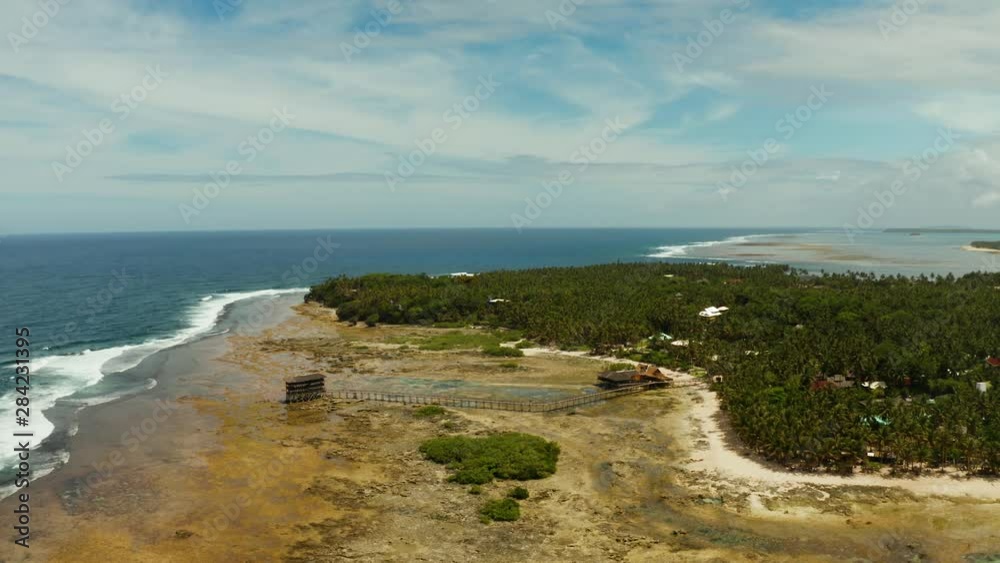 Aerial view of wooden walkway for surfers to cross the reef of siargao island to cloud 9 surfspot. Summer and travel vacation concept Aerial view of wooden walkway for surfers to cross the reef of siargao island to cloud 9 surfspot. Summer and travel vacation concept