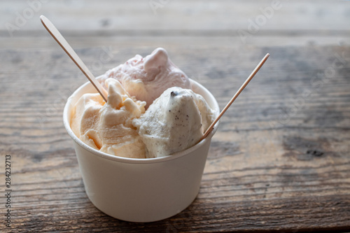 Gelatos in the cup on the wooden table outdoor