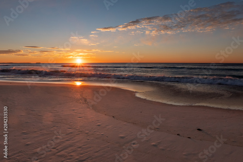 Fototapeta Naklejka Na Ścianę i Meble -  Stunning, golden sunrise over Windang Beach, NSW, Australia