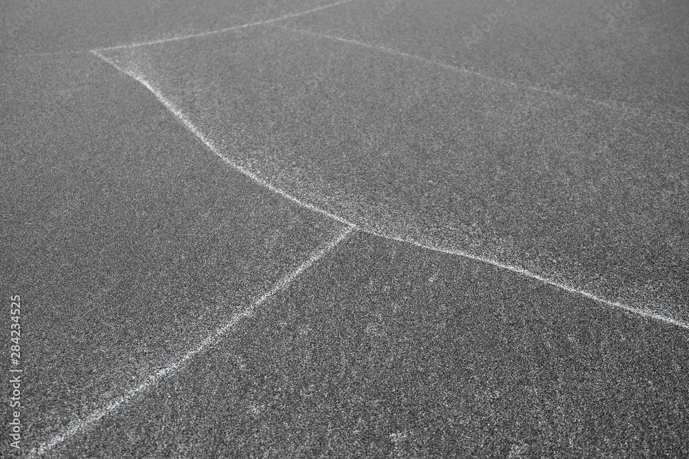 Patterns on sand, white lines left by waves on the beach.
