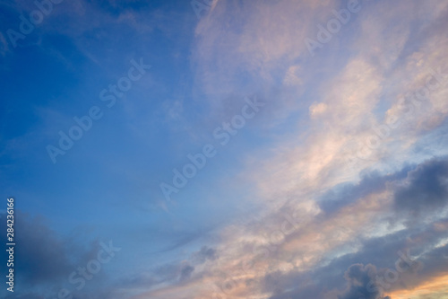 Autumn sunset sky background with warm colored clouds.