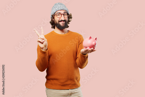 young bearded man with a piggy bank