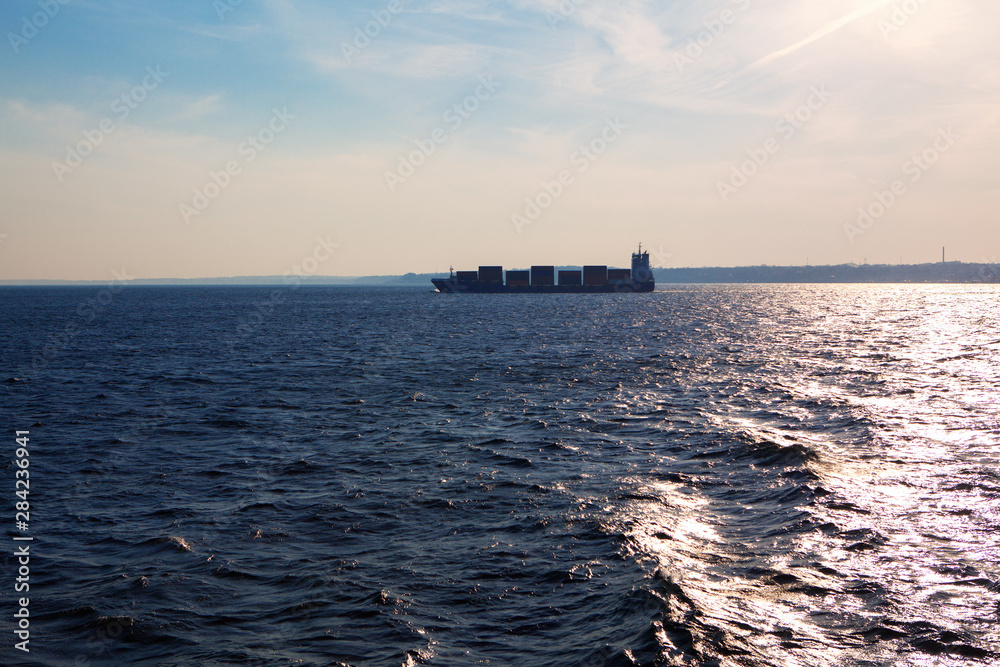 cargo ship container sailing on the horizon 