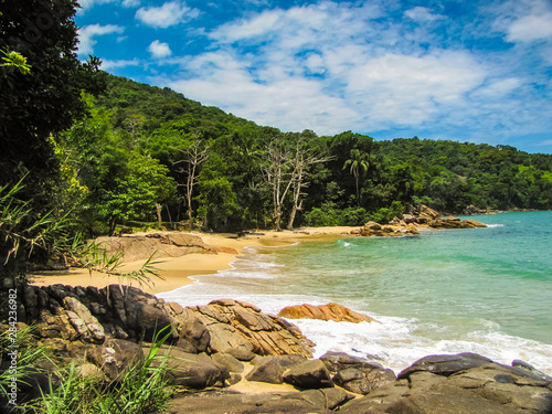 Praia do Deserto, Ubatuba, Sao Paulo, Brazil - Paradise tropical beach with white sand, blue and calm waters, without people on a sunny day and blue sky of the Brazilian coast in high resolution