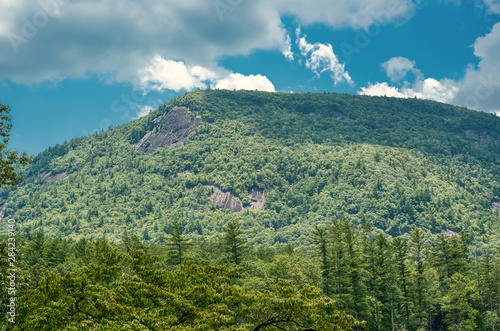 A blue sky over a wooded mountain in the Blue Ridge Mountains in North Carolina.
