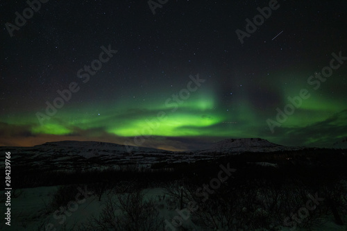 Giant aurora over mountains