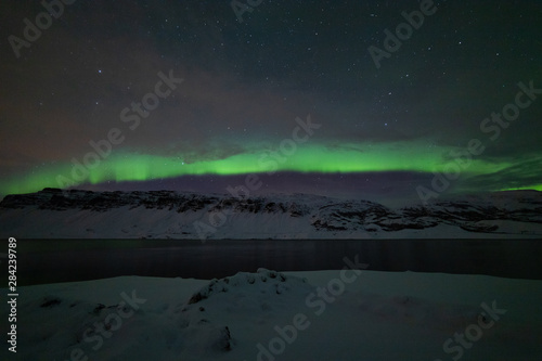 Aurora arching over the fjord